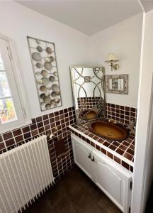 a bathroom with a sink and a mirror at Villa de caractère! Sereine, piscine, plages 5mns! in Port Grimaud +33 photos