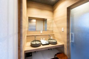 a bathroom with two sinks and a mirror at Itoshima Resort TUMUGU - Vacation STAY 18263 in Fukuoka