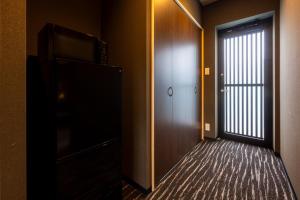 a hallway with a door leading to a room at Itoshima Resort TUMUGU - Vacation STAY 18230 in Fukuoka