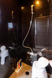 a bathroom with a shower and a toilet and a sink at Itoshima Resort TUMUGU - Vacation STAY 18230 in Fukuoka