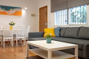 a living room with a couch and a table at Villa Biznaga in Rincón de la Victoria +12 photos