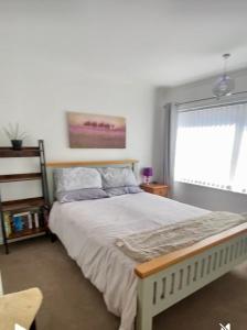 a bedroom with a large bed with a window at Detached Home Close to the Beach Newquay in Saint Columb Minor