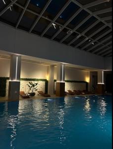 a large swimming pool in a building with a swimming pool at Stylish 28F Gym Free Pkg Secured in Skopje