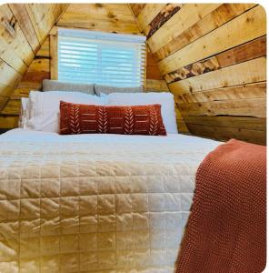 a bedroom with a large bed in a log cabin at 9,000 feet Retreat Above It All in Guffey