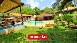 eine Villa mit Swimmingpool in einem Resort in der Unterkunft Pousada Corujão Quadra-SP in Quadra