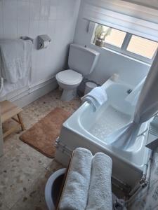 a bathroom with a sink and a toilet and a tub at Casa Pascual in Carnota +20 photos