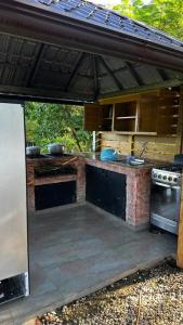 eine Außenküche mit einer Theke und einem Herd in der Unterkunft Villa para grupos in Concepción de La Vega