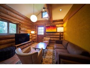 a living room with a couch and a tv at Fiore Shima - Vacation STAY 25653v in Shima