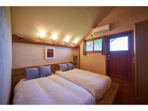 two beds sitting next to each other in a room at Fiore Shima - Vacation STAY 25653v in Shima +13 photos
