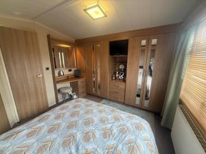 a bedroom with a large bed in a room at Oceanretreatholidays in Burry Port