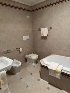 a bathroom with a tub and a toilet and a sink at Montenegro Seaside Lux Apartment in Petrovac na Moru +20 photos