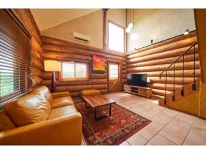 a living room with a couch and a table at Fiore Shima - Vacation STAY 25654v in Shima