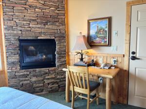 a room with a desk and a fireplace at Amazing Lake View 2 Queen Bed Studio & Heated Pools in Two Harbors