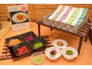 a table with bowls of food on a table at Dogashima Onsen Hotel - Vacation STAY 55278v in Tago