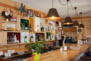 a bar with lots of bottles on the shelves at Hotel Casa Arcas in Villanova