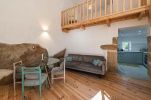 a living room with a table and a couch at Casa do Adro in Idanha-a-Nova