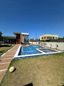 a swimming pool in the backyard of a house at Casa de Temporada Camaçari in Barra de Jacuípe +19 photos