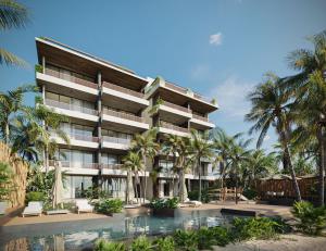 a resort with a swimming pool and palm trees at Aytana Luxury Living in Chuburná