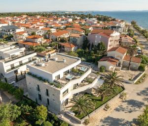 an aerial view of a city with houses and the ocean at Apartments Dernaj in Vir