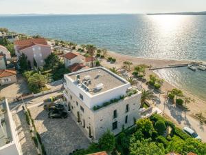 an aerial view of a house next to the water at Apartments Dernaj in Vir