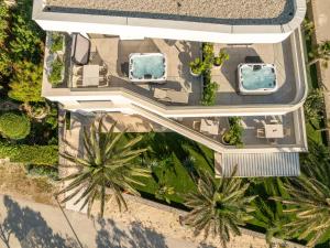 an overhead view of a villa with two swimming pools and palm trees at Apartments Dernaj in Vir +74 photos