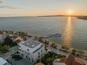 an aerial view of a building next to the water at Apartments Dernaj in Vir