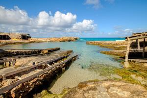 a body of water with rocks and the ocean at Casa Garrover in Illes Balears