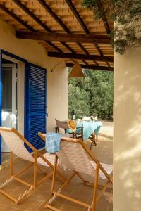 a patio with a table and two chairs and a table at Casa Garrover - Calma entre Sabinas in Illes Balears +24 photos