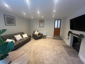 a living room with a couch and a fireplace at Church street, Pateley Bridge Yorkshire Dales in Pateley Bridge