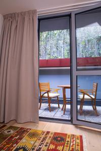 a room with two chairs and a table and windows at Varanini Luxury Suites double bedroom plus two and sauna in Milan