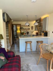 a kitchen and living room with a table and chairs at Hot tub on the Yorkshire Wolds Oak Cottage in South Cave
