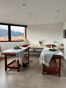 a room with two tables with towels on them at Cosmos 100 Hotel & Centro de Convenciones - Hoteles Cosmos in Bogotá