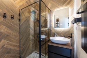 a bathroom with a sink and a glass shower at Gora Apartments 3 in Vrdnik