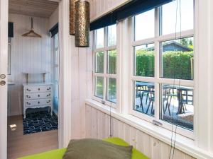 a living room with windows and a green couch at 4 star holiday home in Grenaa-By Traum in Grenå