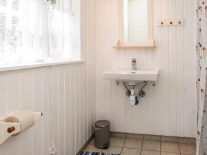a white bathroom with a sink and a window at 4 star holiday home in Grenaa-By Traum in Grenå +32 photos