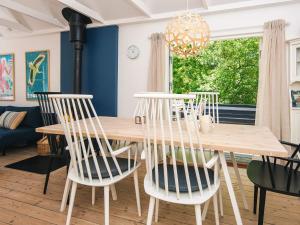 a dining room with a wooden table and chairs at 6 person holiday home in Grenaa in Grenå