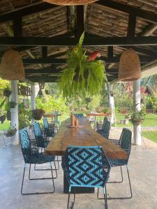 a wooden table and chairs on a patio at ALMAH GLAMPING in Cali