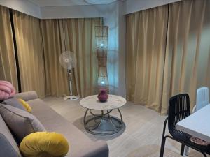 a living room with a couch and a table at Tambuli Beach Ocean view condo in Lapu Lapu City