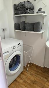 a laundry room with a washing machine in it at Flamingo Palmar in Palm-Mar