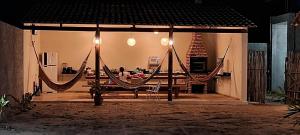 a group of people sitting in a hammock on a stage at Casa na lagoa do Paraíso- Villa Bem Estar in Jericoacoara