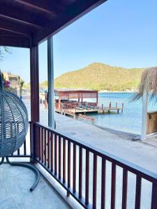a balcony with a view of a body of water at AKSOY TAŞ EV in Bodrum City +50 photos