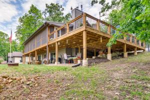 a large wooden house with a large deck at Truman Lake Retreat Large Deck and On-Site Fishing! in Clinton