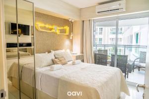 a bedroom with a bed and a balcony at Apt. Beira Mar em Cotovelo In Mare 137 - QAVI in Granja Beira Mar +19 photos