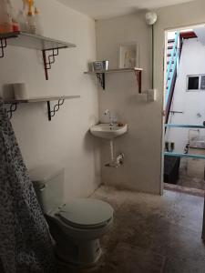 a bathroom with a toilet and a sink at 888 Casa Cabal Budget Rental 888 in Cancún