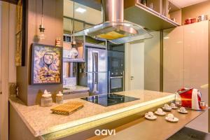a kitchen with a counter with a stove top oven at Apt. Beira Mar em Cotovelo In Mare 137 - QAVI in Granja Beira Mar