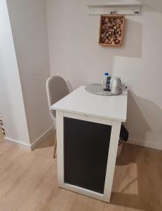 a white desk in a room with a chair at Monteiro Duplex Terrace - attic in Mercês +2 photos