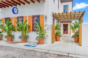 a building with potted plants in front of it at 61 Spanish St. Unit A in St. Augustine