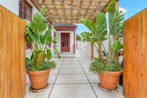 a corridor with plants in pots on a house at 61 Spanish St. Unit B in St. Augustine