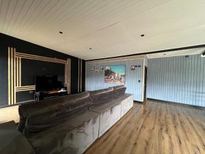 a living room with a couch and a television at The Black House in Recinto