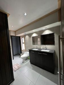 a bathroom with a sink and a toilet and a mirror at The Black House in Recinto +54 photos